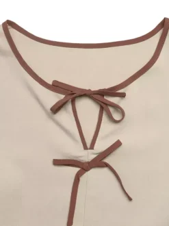 Blouse péplum à col rond et n艙ud contrastant manches bouffantes et manches bouffantes