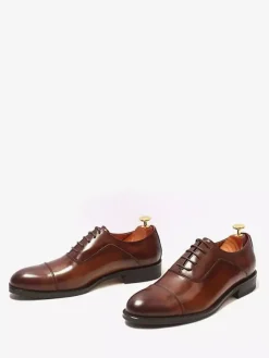 Chaussures Oxford noires à bout rapporté pour hommes en cuir véritable à lacets.