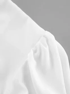 Chemisier péplum blanc élégant pour femme - Col V dos nu manches lanternes coupe ajustée - Idéal pour le printemps et le soir (2026)