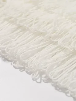 Ensemble 2 pièces pour femme : jupe blanche élégante à franges et revers manches longues.