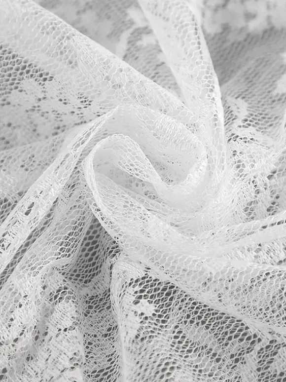 Jupe longue à volants en dentelle florale transparente à taille élastique noire et blanche transparente.