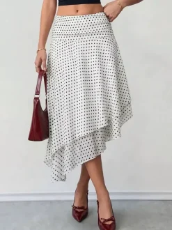 Jupe midi blanche à petits pois taille haute ourlet asymétrique à volants irréguliers en mousseline fluide.