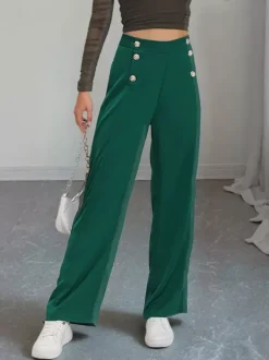 Pantalon de costume taille haute à double boutonnage et jambes larges coupe drapée.