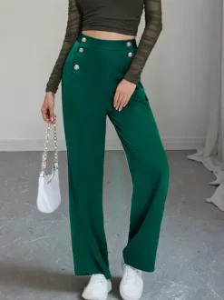 Pantalon de costume taille haute à double boutonnage et jambes larges coupe drapée.
