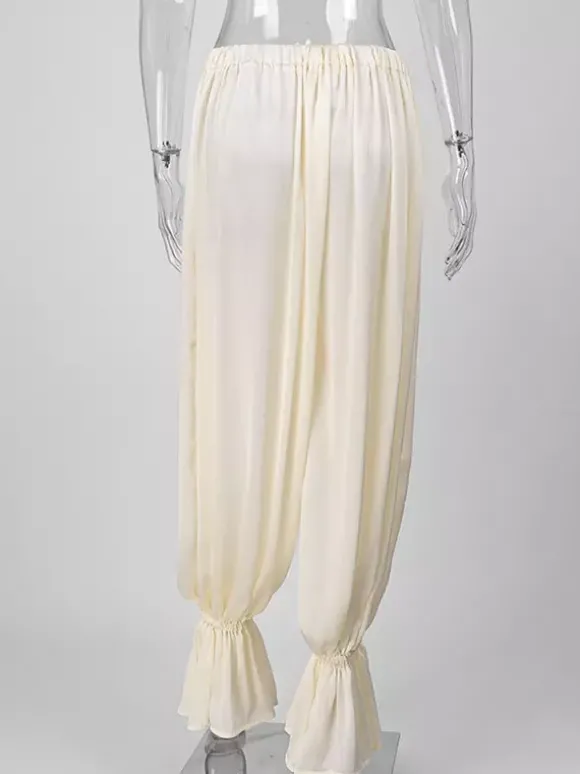 Pantalon harem fluide et drapé à taille haute élastique et ourlet à volants jambes larges.