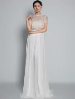 Robe de mariée deux pièces ivoire haut en dentelle col rond boutonné sur dos jupe en tulle