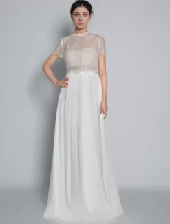 Robe de mariée deux pièces ivoire haut en dentelle col rond boutonné sur dos jupe en tulle