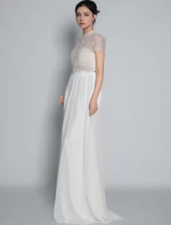Robe de mariée deux pièces ivoire haut en dentelle col rond boutonné sur dos jupe en tulle