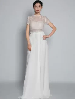 Robe de mariée deux pièces ivoire haut en dentelle col rond boutonné sur dos jupe en tulle