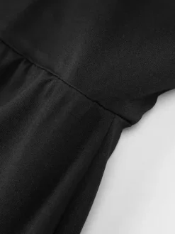 Robe de soirée noire moulante mini à dos nu et ornée de rivets tenue de boîte de nuit