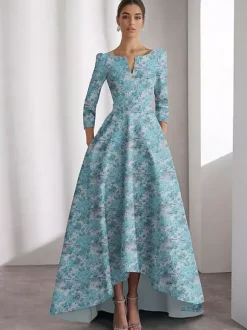 Robe de soirée pour la mère de la mariée décolleté travaillé manches 3/4 coupe trapèze imprimé floral longueur thé idéale pour un mariage.