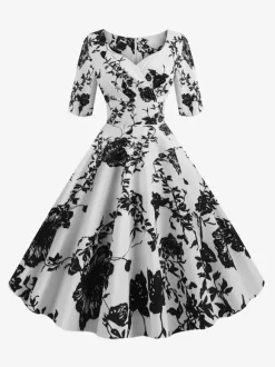 Robe glamour vintage noire style années 50 imprimé floral manches mi-longues superposées décolleté c艙ur taille M style rockabilly