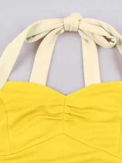 Robe jaune dos nu vintage swing avec ceinture blanche contrastante style rockabilly rétro années 50