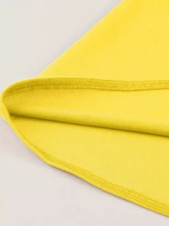 Robe jaune dos nu vintage swing avec ceinture blanche contrastante style rockabilly rétro années 50