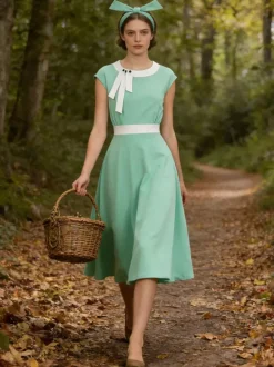 Robe swing vintage pour femme années 1950 ornée de détails contrastés col à n艙ud idéale pour un tea party.