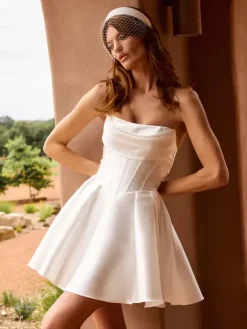Robe de mariée courte décolleté court manches 3/4 taille naturelle en satin.