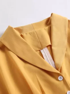 Robe glamour vintage à col rabattu et boutons style années 50 manches courtes taille moyenne jaune rockabilly