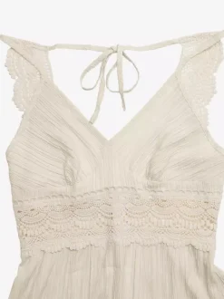 Robe longue fluide d'été pour femme couleur crème avec bretelles spaghetti et taille en dentelle blanche col en V.