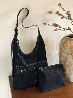 Sac hobo vintage en daim avec surpiqûres contrastées bandoulière ajustable et porte-monnaie intégré.
