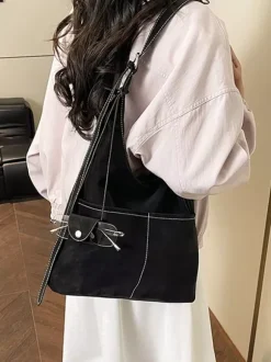 Sac hobo vintage en daim avec surpiqûres contrastées bandoulière ajustable et porte-monnaie intégré.