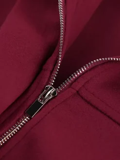 Veste bomber courte rouge bordeaux à col minimaliste fermeture éclair intégrale et poignets élastiques